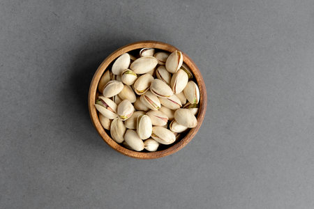 Pistachio nuts in wood cup ,closeup. Copy space for your text.の写真素材