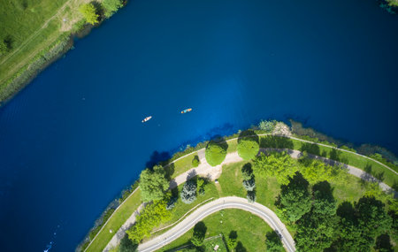 Two sports sup boards from a bird's eye view. Aerial view of blue lake and green forest on a sunny...