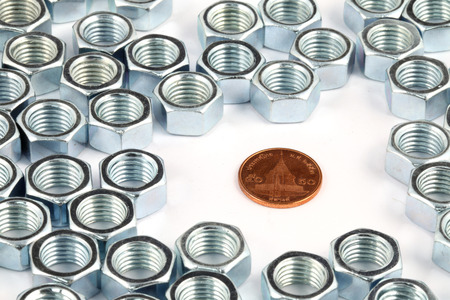 coin in array of metal  nut on white backgroundの写真素材