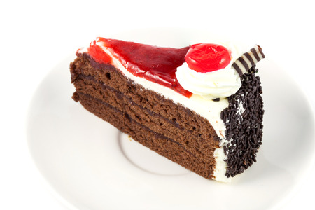 close up cake with cherry on white backgroundの写真素材