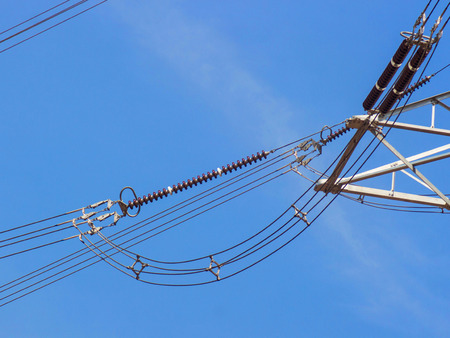 a high voltage power pylons against blue sky