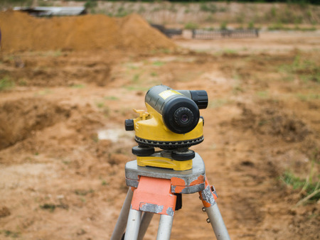Surveying measuring equipment level theodolite on tripod at construction siteの写真素材