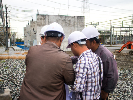 Successful businessteam of four sitting in office and planning workのeditorial素材