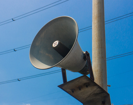 Loudspeaker or megaphone on sky background. 
