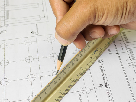 Design drawings and human hands drawing a project by pencil on paper