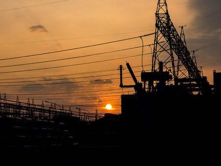 Part of high-voltage substation with switches and disconnectors with sunsetの写真素材