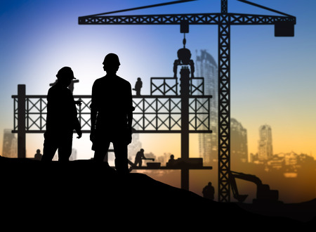 silhouette engineer looking construction worker in a building site over Blurred construction siteの写真素材