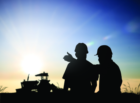 silhouette man survey and civil engineer stand on ground working in a land building site over Blurred construction worker on construction site. examination, inspection, surveyの写真素材