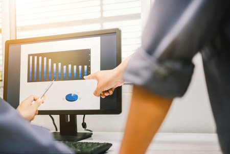 Business people working together at office. Business people discussing the charts and graphs showing the results of their successful teamwork.の写真素材