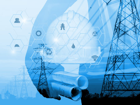 silhouette of engineer working with blueprints in the background of high-voltage towerの写真素材