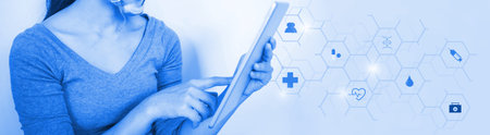 woman young  doctor hand holding blur tablet shows a list of patients and icon medical network connection on virtual screen interface.Vaccination concept. laboratory, medical and healthcareの写真素材