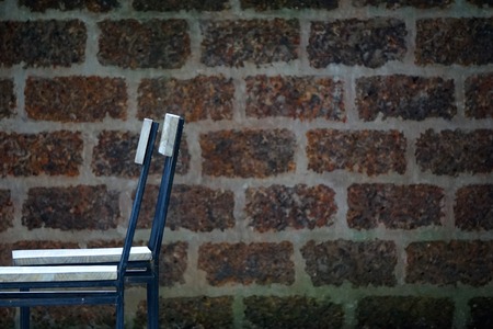Outdoor chair and the brick wall on holiday coffeeの写真素材