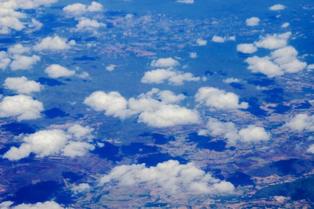 Cumulus cloud and field from airplane viewの写真素材