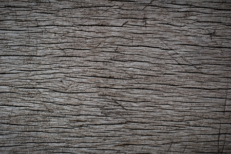 Dark brown scratched wooden cutting board. Wood textureの写真素材