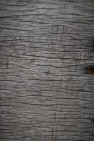 Dark brown scratched wooden cutting board. Wood textureの写真素材