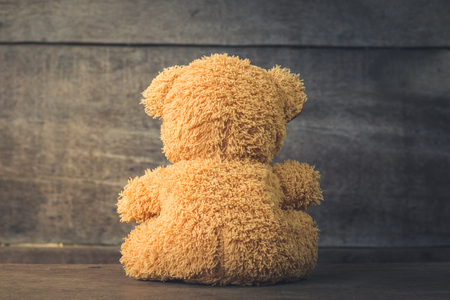 Teddy bear sitting, turned on wood, Vintage Toneの写真素材