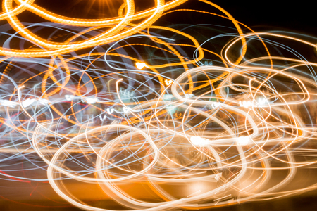 Light trails against dark background on roadの写真素材
