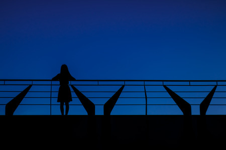 Silhouettes background, Women's one person standing on the balcony.の写真素材