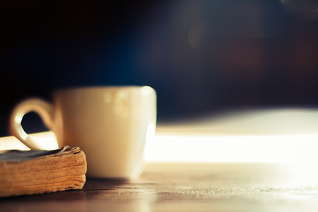 Old book on wooden library desk, retro toned image, selective focusの写真素材