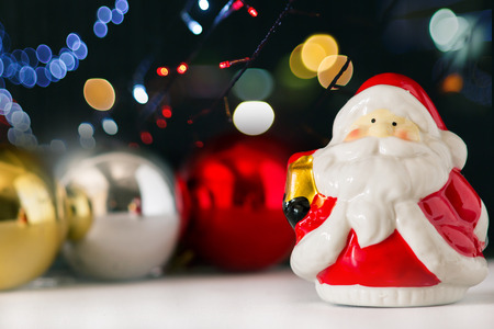 Santa Clause toy on blurry light background, Christmas backgroundの写真素材