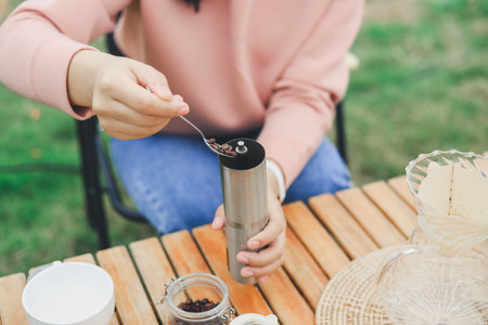 Drip coffee on vacation outdoor and drinking a cup of hand coffee in autumn morning. relax and enjoy outdoor lifestyle and holiday travel vacation.の写真素材