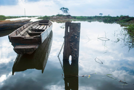 Fishing boat in countryside. Beautiful sunrise over a wooden traditional boat.の写真素材