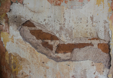 Old brick wall partially damaged, Old cement wall texture. Old cement wall one hundred and thirty two yearsの写真素材