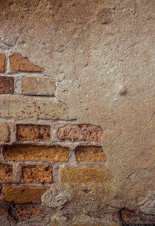 Old brick wall partially damaged, Old cement wall texture. Old cement wall one hundred and thirty...