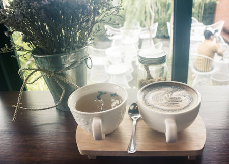 Coffee cup and tea cup in coffee shop - vintage tone hipster styleの写真素材