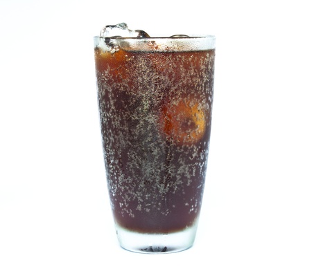 ice cube splashing into glass of coke white background. の写真素材