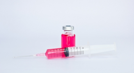 medical ampoules and syringe isolated on white  の写真素材