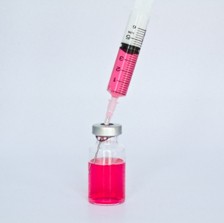 syringe sucks the vaccine from a bottle  の写真素材