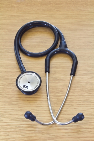 Photo of a dual head high quality stethoscope used for medical examinations in the healthcare and fitness industries isolated on a white wood floor  の写真素材