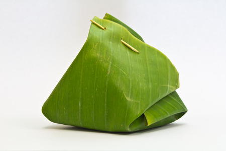Thai dessert, Sticky rice with steamed custard, wrapped in banana leaves  の写真素材