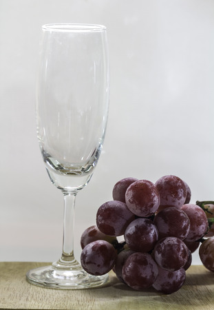 Fresh grapes with wine glass isolated on whiteの写真素材