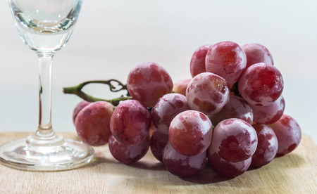 Fresh grapes with wine glass isolated on whiteの写真素材