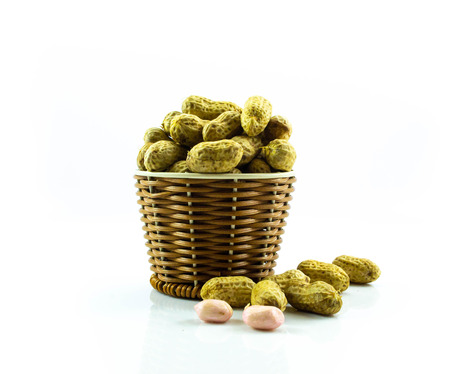 Peanut in wooden isolated on white background