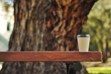 Coffee cup with wooden trunk backgroundの写真素材