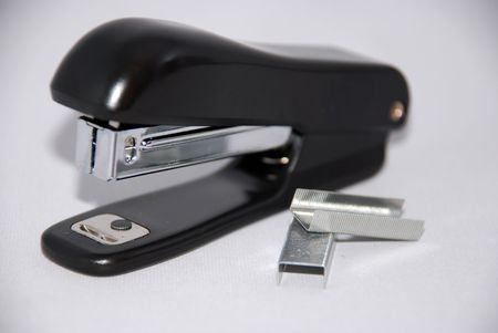 Staples along with stapler in the backgroundの写真素材