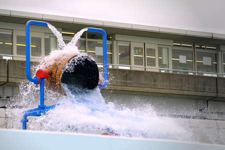 Water slide in the form of a barrel with water splashes.