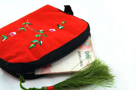 Chinese tradition wallet with money on the white の写真素材