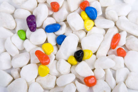 white pebbles and color pebbles close up shotの写真素材