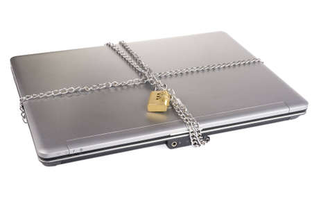 Laptop with chains and combination padlock isolated on whiteの写真素材