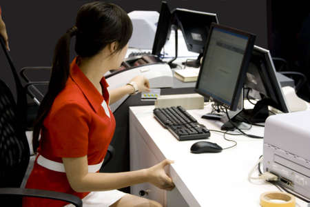 Young business woman at work in bank の写真素材