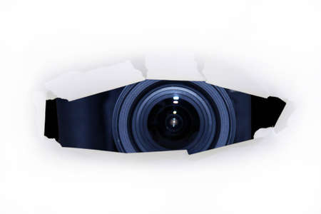 a zoom lens through cut paper holeの写真素材