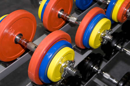 Closeup of colorful dumbbells in a gym or studioの写真素材