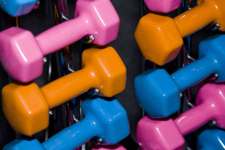 Closeup of colorful dumbbells in a gym or studioの写真素材