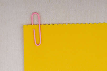 paper clip and blank note on a board