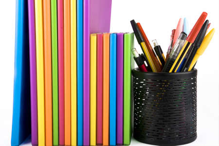colour notebooks and pen container on white background
