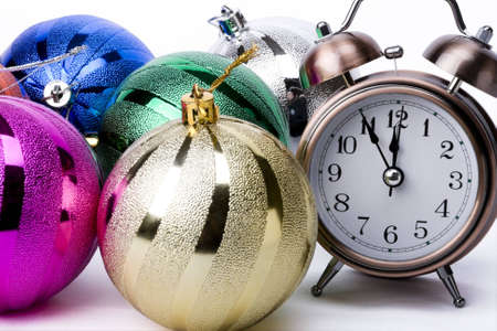 Alarm clock and christmas decorations on a white backgroundの写真素材